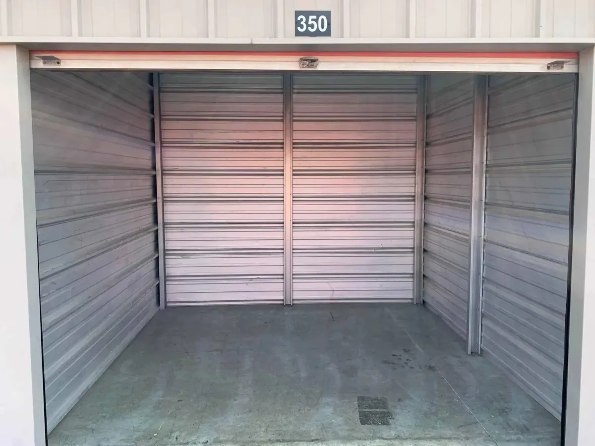 Clean, empty storage unit with the roll-up door open
